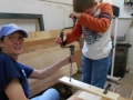 Dawn Barnett, 4-H agent for East Feliciana Parish, help one of the kids use a brace and bit to drill some holes