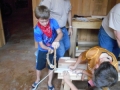 Kids using the bow drill as Mark supervises